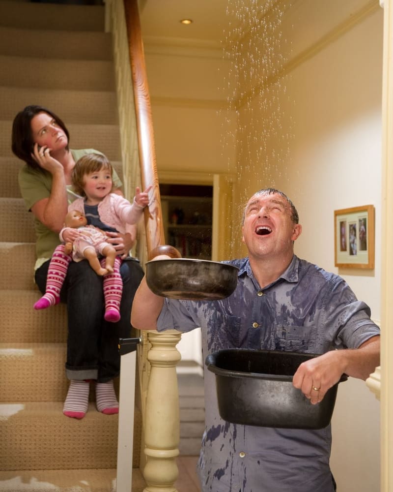 Homeowners responding to an active roof leak inside their home